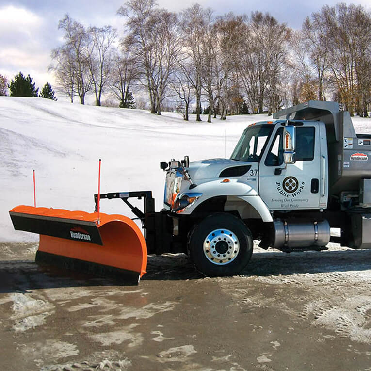 A Henderson Snow Plow parked on freshly plowed pavement